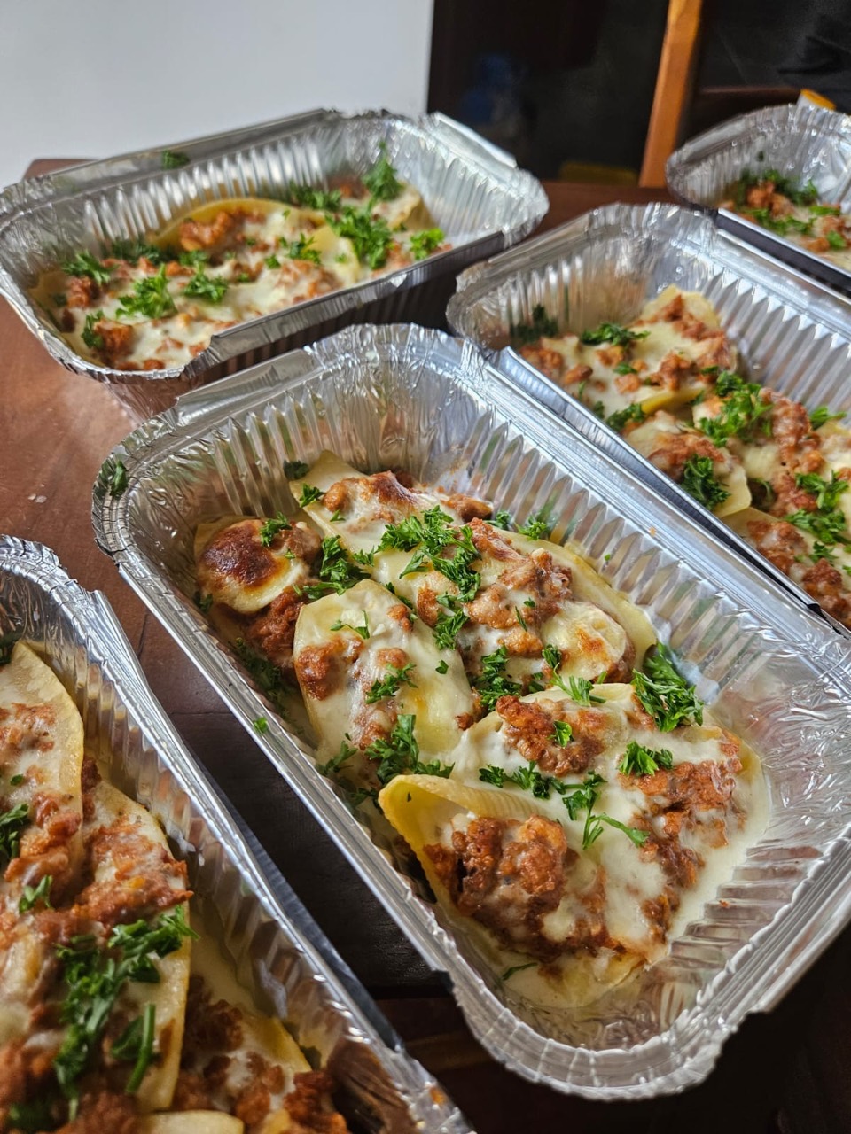 Freshly prepared baked pasta meals topped with herbs